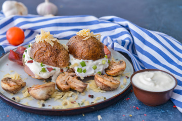 Tasty baked potato with sour cream and mushrooms on plate