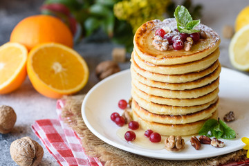 Delicious fresh beautiful pancakes with citrus honey and jam