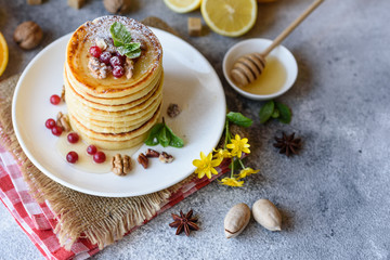 Delicious fresh beautiful pancakes with citrus honey and jam