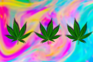 green cannabis leaf on a blurred holographic psychedelic background