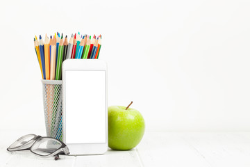 Naklejka premium Workplace with smartphone, supplies and apple
