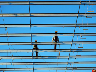 Man Working on the Working at height on construction site with blue sky