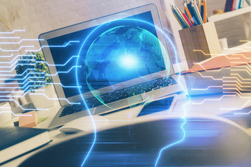Double exposure of work space with computer and human brain drawing hologram. Brainstorm concept.