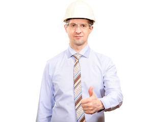 Confident male engineer in white construction helmet, shirt, tie, smiles, shows gesture OK, thumb up, looks into camera. Isolated