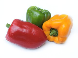 Red, yellow and green bell peppers in isolated white background. 