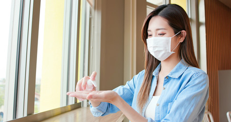 asian woman use sanitizer gel