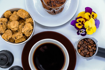 Coffee cup and beans on white background. Top view
