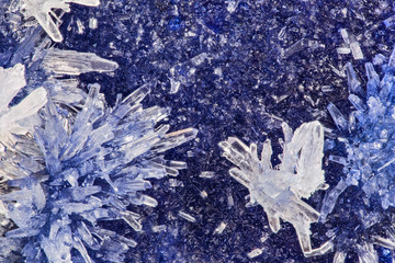 blue and white crystals on dark background