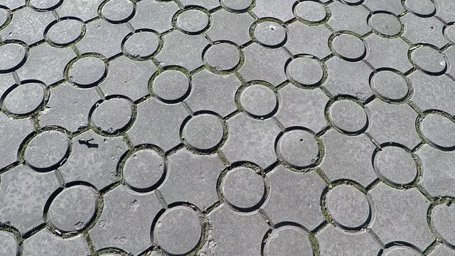 texture, background paving tile gray concrete in round shape, camera movement forward, bright daylight