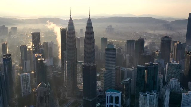Aerial Time lapse, Hyperlapse of the Twin tower at Kuala lumpur, Malaysia during Sunrise under low level clouds.