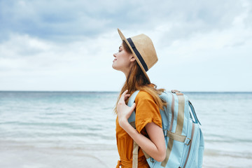 young woman reading a book on the beach