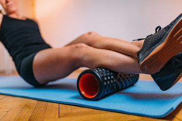 Massaging Calf Muscles with Foam Roller © Microgen