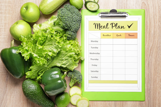 Healthy Products And Meal Plan On Wooden Background