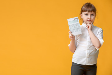 Little girl with calculator on color background