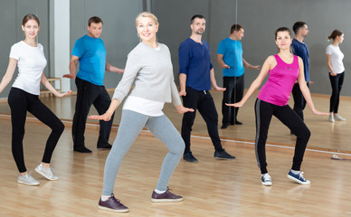 Fototapeta na wymiar Middle-aged woman exercising at dance class