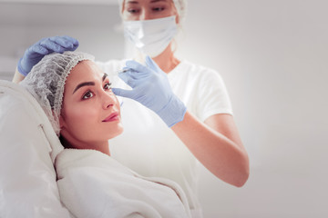 Naklejka premium Pretty woman enjoying mesotherapy visiting favorite cosmetologist
