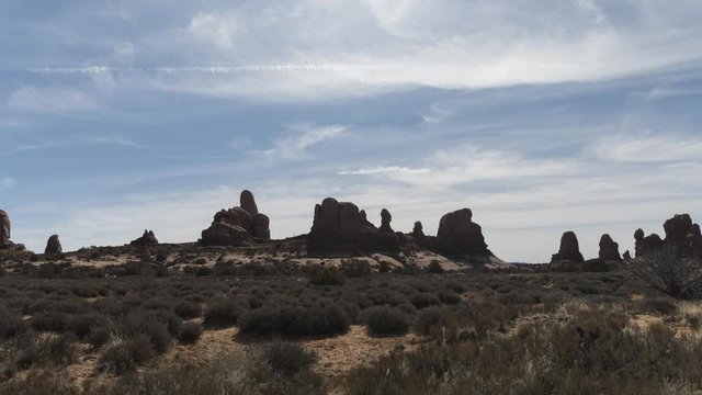 A long-lens timelapse of the Windows section of Arches National Park on a winter morning.