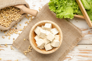 Bowl with tasty tofu cheese on table