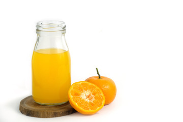 Fresh orange juice above wood coaster, with raw, sliced orange fruit – isolated on white background