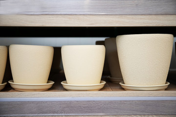 Ceramic flower pots on a rack in a store. gardening Tools