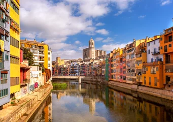 Fototapeten Colorful houses on the Onyar river with reflection in the water on a summer sunny day. The sights of Girona are cities in Catalonia, Spain. City landscape.  © myschka79