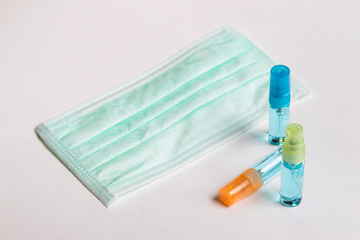 Alcohol spray and surgical mask for protect against COVID-19 Coronavirus and clear bacteria. Hygiene concept.