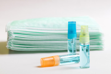 Alcohol spray and surgical mask for protect against COVID-19 Coronavirus and clear bacteria. Hygiene concept.
