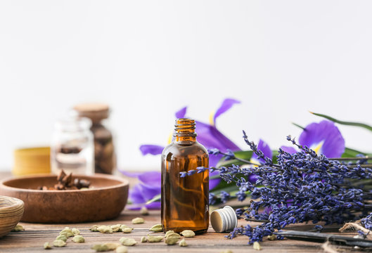 Bottle of perfume with ingredients on table