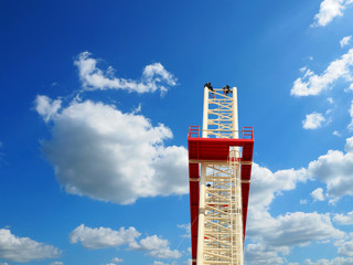 Man Working on the Working at height on construction site with blue sky