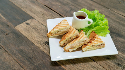 Sandwich tuna and cheese on a white plate.