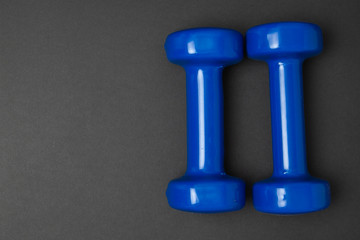 Two blue of dumbbells Isolated on black background