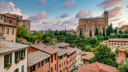 Siena, Toscana, Italy - September 2014: Amazing sunset overlooking the Basilica Cateriniana di San Domenico