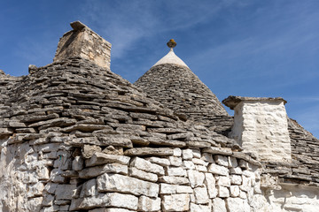 Fototapeta na wymiar Stone roof of Trulli House in Alberobello, Italy. The style of construction is specific to the Murge area of the Italian region of Apulia (in Italian Puglia). Made of limestone and keystone.