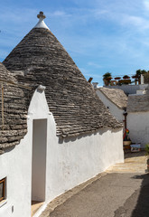 Fototapeta na wymiar Trulli village in Alberobello, Italy. The style of construction is specific to the Murge area of the Italian region of Apulia (in Italian Puglia). Made of limestone and keystone.