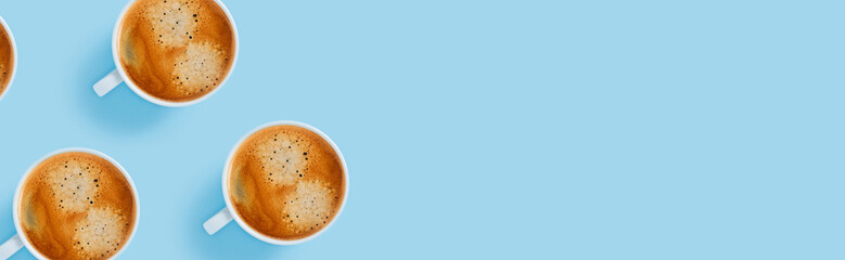 Morning cup of strong coffee with five pieces of sugar in the shape of hearts on blue background.