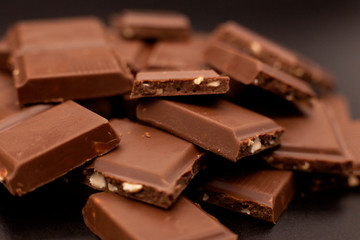 Lots of chocolate. Chocolate with nuts. Chocolate pieces with nuts. Broken chocolate with nuts.