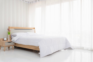 Fototapeta na wymiar Interior white bedroom with white curtains.
