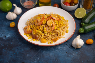 Shrimp Stir Fry with pasta and ingredients, zucchini, lime, cherry tomatoes, garlic and seasonings. With space