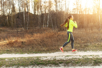 A young fit woman in sportswear is jogging outdoor