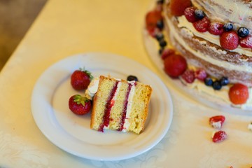 Decorated by fruits colorful naked cake, rustic style for weddings, birthdays and events.
Beautiful wedding cake, close up of cake and blur background, selective focus.