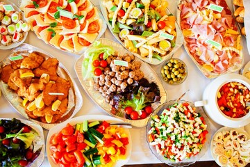 Food and drink at the restaurant. Table setting. Tasting dishes.
Set of cold snacks, canape, beverages, closeup  parte meals
Meals set for holiday, event, party or reception in outdoor restaurant.