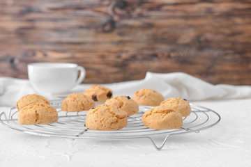 Cooling rack with sweet cookies on table