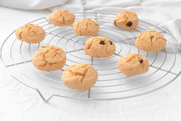 Cooling rack with sweet cookies on table
