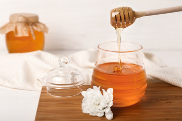 Jar of sweet honey on table