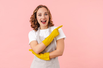 Optimistic young woman housewife in gloves