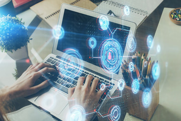 Multi exposure of technology hologram with man working on computer background. Concept of big data.