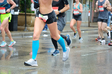 Marathon running race, many runners feet on road racing, woman on sport competition, fitness and healthy lifestyle concept
