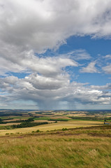 The view towards the East Coast of Scotland from the Summit of the White Caterthun Iron Age Fort, with Rain Clouds in the Distance.