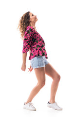 Naklejka premium Young curly hair girl fashion model in delicate relaxed posture looking up and modelling. Full body isolated on white background. 