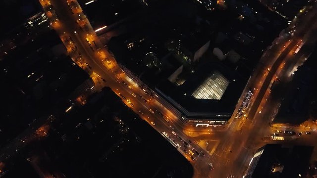 Cars riding on lit up streets in city aerial